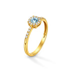Anello Magic con zircone acquamarina centrale e contorno di micro-zirconi bianchi